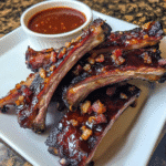 How to make Smoky BBQ Bacon Glazed Ribs with Tangy Sauce — key cooking step